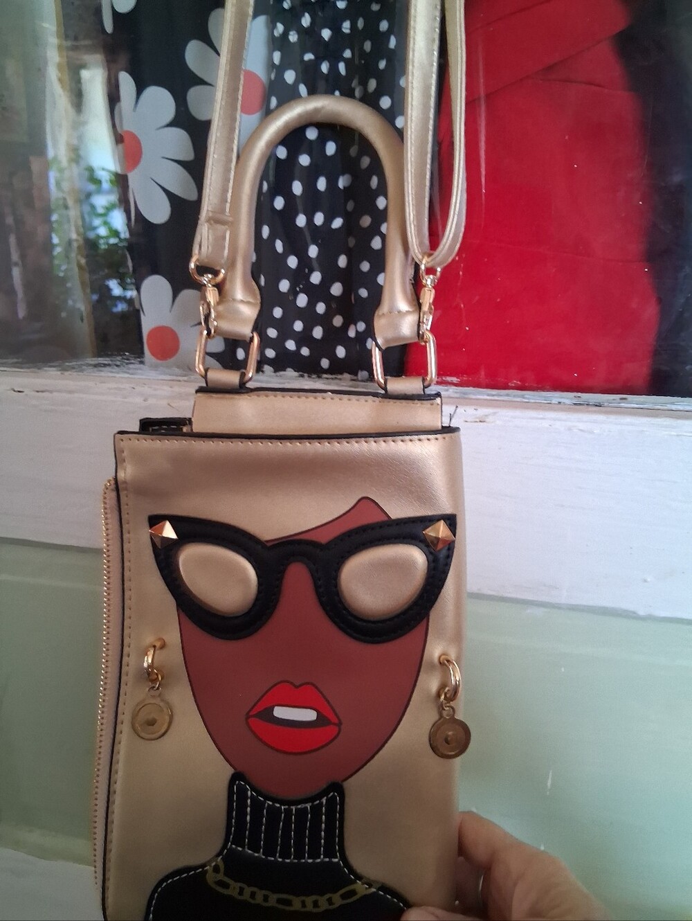Fashionable Gold Crossbody Bag with Graphic Face Design